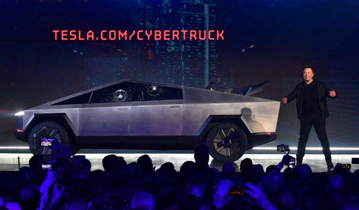 Tesla co-founder and CEO Elon Musk on stage with the newly unveiled all-electric battery-powered Tesla Cybertruck with broken glass on windows following a demonstation that did not quite go as planned on November 21, 2019 in California
