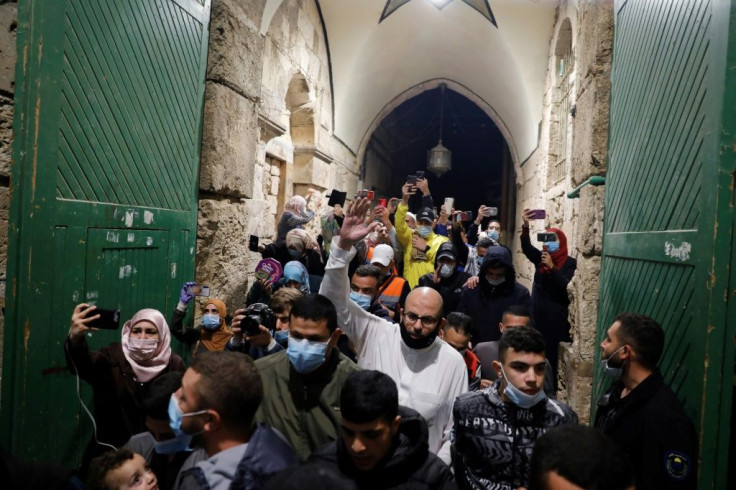 Palestinian Muslim worshippers enter the al-Aqsa mosque compound for early morning prayers