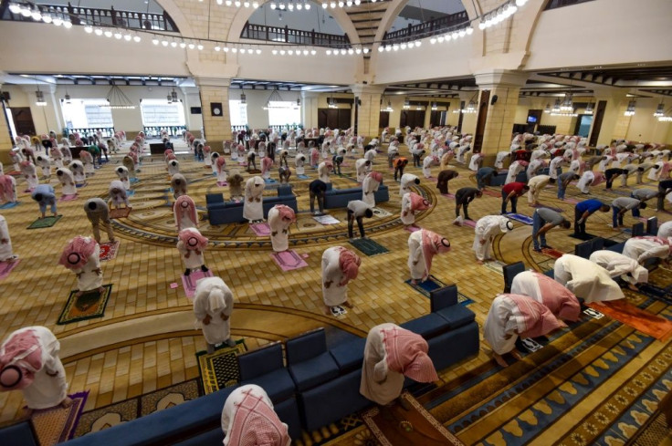Saudi Muslim worshippers maintain a safe distance as they perform noon prayers at Al-Rajhi mosque in the capital Riyadh on Sunday