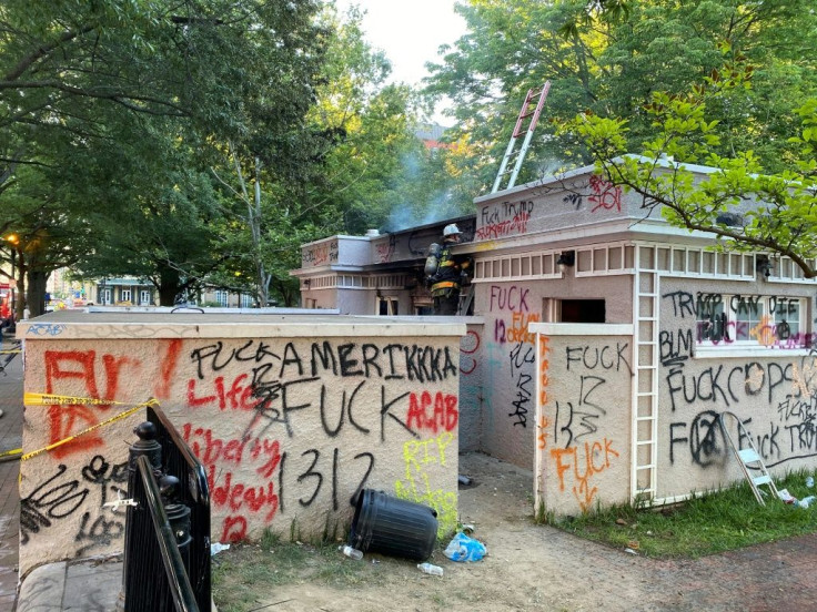 Graffiti left by demonstrators protesting the death of George Floyd is seen at Lafayette Square near the White House