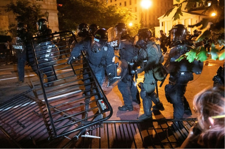 Police charge a barricade in the street during a demonstration against the death of George Floyd, near the White House on May 31, 2020 in Washington