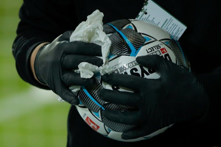 Staff disinfect match balls in the Bundesliga