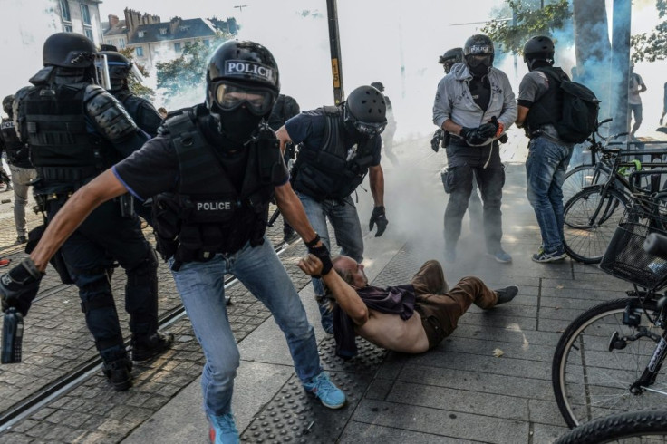 Police arrest a protester at a protest called last August in memory of Steve Maia Canico, who whose body was found in the River Loire a month after he went missing during a police raid on a music festival at the western city of Nantes