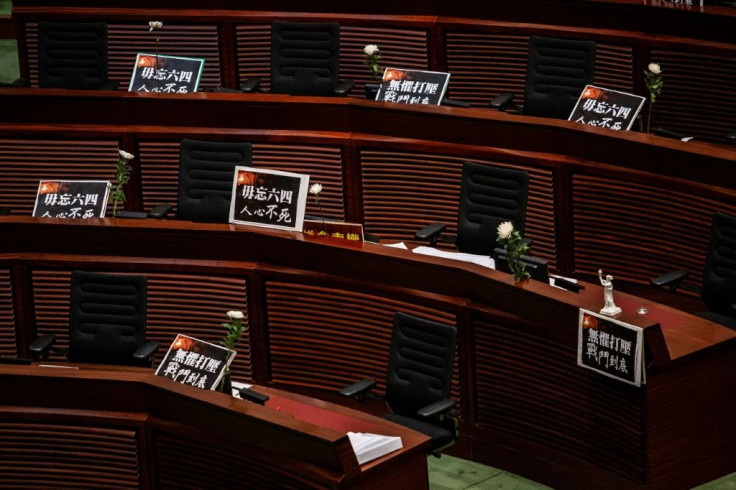 Placards and flowers are left in front on empty seats as pro-democracy legislators walk out of the chamber as debate continues in Hong Kong on June 4, 2020, ahead of a vote over a law that bans insulting China's national anthem