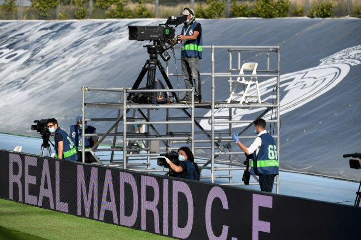 Camera opportunity: TV crews were among the few people allowed into the ground as Real Madrid kicked off on Sunday