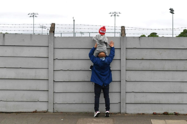 No peeking: While fans tried to get a glimpse of Liverpool training, police want them to stay away from the Merseyside derby