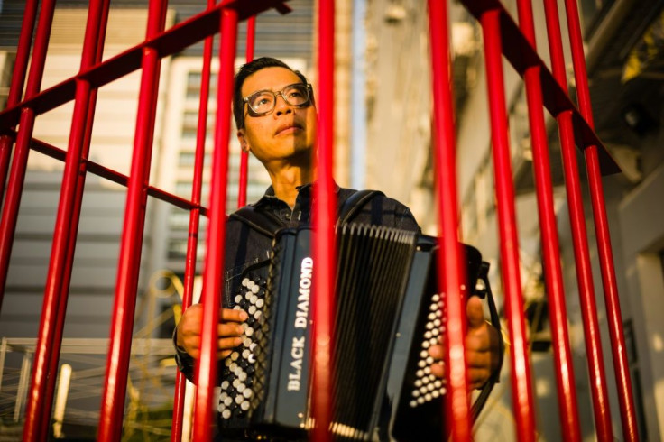 Kacey Wong's performance art involved playing China's national anthem as he sat in a cage