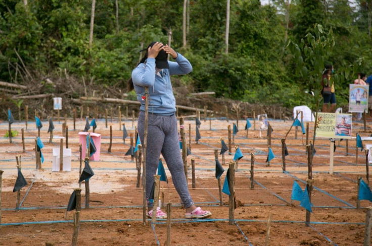A relative of a victim of COVID-19 gestures as she takes part in a protest at the site of a common grave near Iquitos, Peru, on June 27, 2020