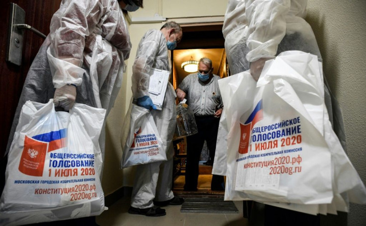 A voter casts a ballot into a mobile ballot box in Moscow during the early vote in a nationwide constitutional referendum that could extend President Vladimir Putin's term