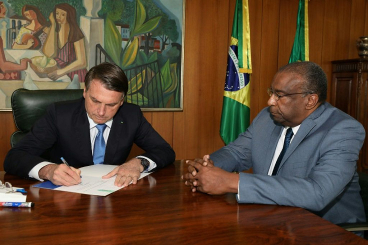 Carlos Alberto Decotelli (R, pictured June 26, 2020 in a handout picture released by Brazilian Presidency press office) had claimed several academic credentials that were vaunted by President Jair Bolsonaro but are accused to be false