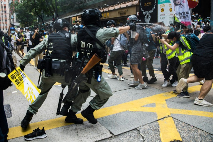 Riot police deploy pepper spray towards journalists as protesters gathered for a rally against a new national security law in Hong Kong on July 1