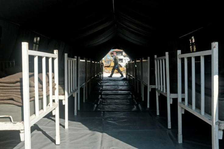A Serbian army soldier walks past a makeshift field hospital to accomodate patients in the city of Novi Pazar on July 3, 2020