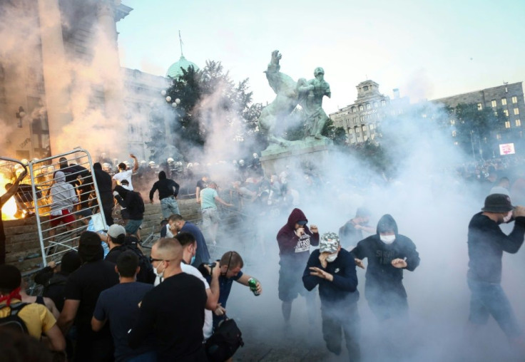 Clouds of tear gas and smoke filled central Belgrade after a peaceful gathering descended into tense confrontations between protesters and police