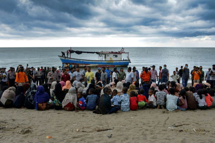 Evacuated Rohingya people from Myanmar sit on the shorelines of an Indonesian village