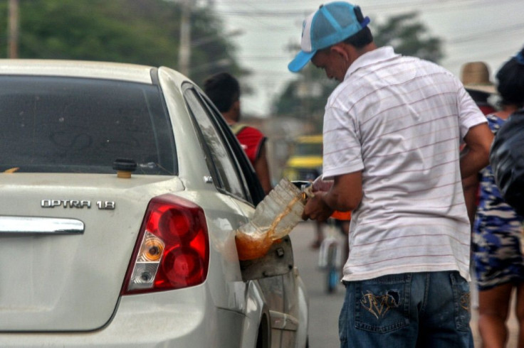A man fills his car with gasoline purchased on the streets of Maracaibo, Venezuela in July 2020