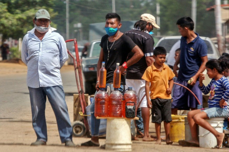 People offer gasoline for sale on the streets of Maracaibo, Venezuela in July 2020