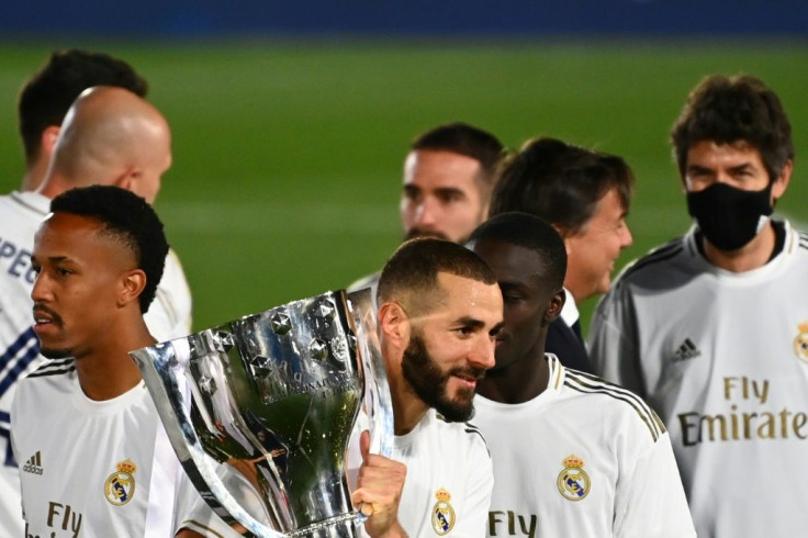 Benzema celebrates with the trophy Real clinched the title