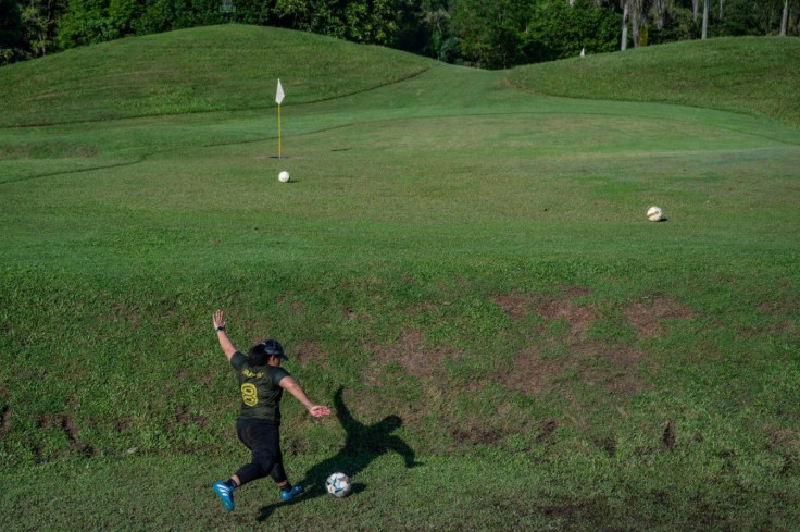 Chipping up: Jamiatul Akmal Abdul Jabar tries to find the green during a round of "footgolf"