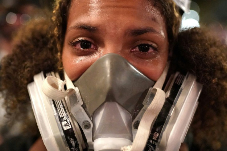 Teal Lindseth reacts to tear gas after federal officers dispersed protesters from in front of the Mark O. Hatfield US Courthouse on July 20, 2020 in Portland