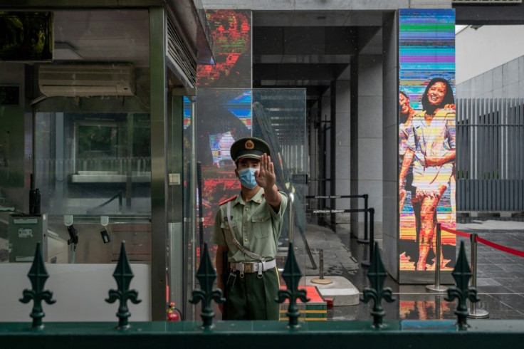 A Chinese paramilitary police officer stands at the entrance of the Australian embassy in Beijing in July 2020 amid high tensions