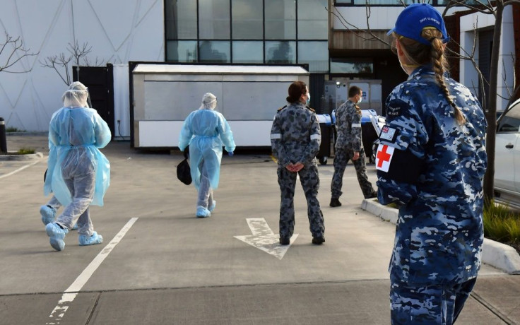 Australian Defence Force personnel escort their staff into the Epping Gardens facility