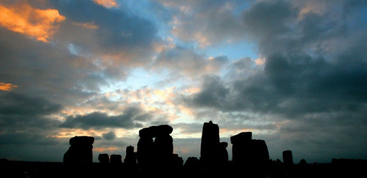 The stone circle of Stonehenge is silhouetted at sunrise during the pagan festival, Summer Solstice, in Avebury, Wiltshire, 21 June 2007