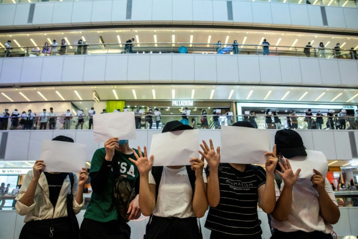 Silent protests with no writing on posters have emerged in Hong Kong to circumvent China's crackdown on the democracy movement