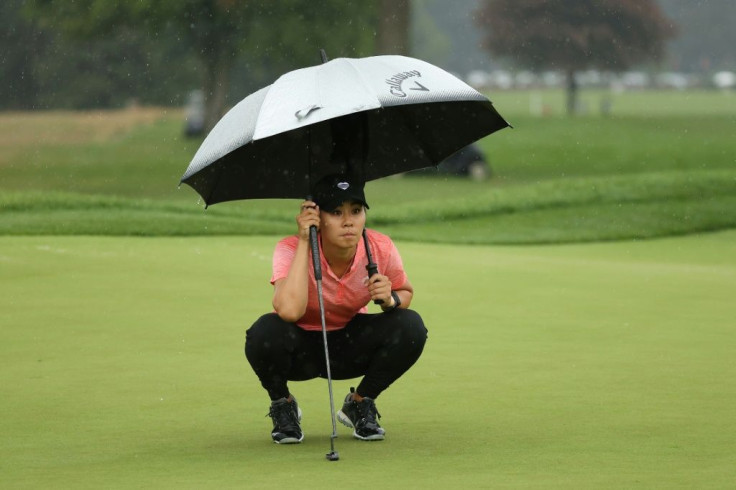 American Danielle Kang lines up a putt under an umbrella Saturday on her way to a one-over par 73 that kept her in a share of the lead at the LPGA Drive On Championship at Inverness Club in Toledo, Ohio