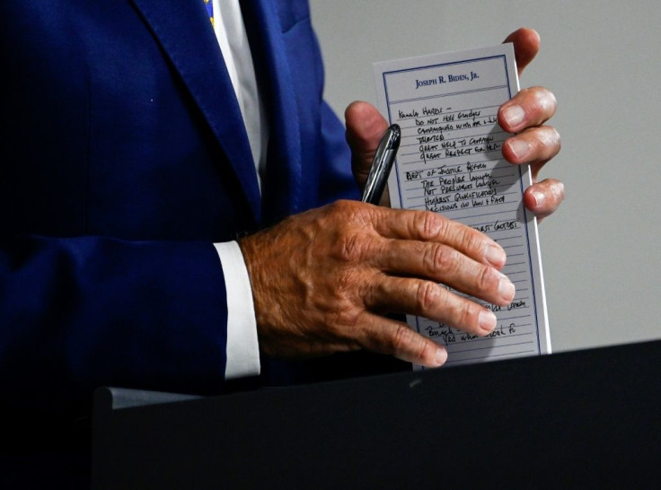 US Presidential candidate and former Vice President, Joe Biden holds a pad with potential Vice Presidential names on it and other notes, during a campaign event at the William "Hicks" Anderson Community Center in Wilmington, Delaware on July 28, 2020.