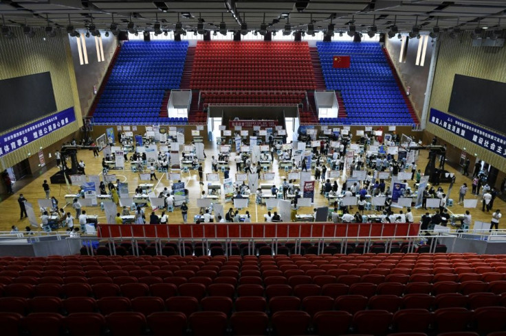 Hundreds of young Chinese stream in and out of a job fair on a recent weekend in Zhengzhou