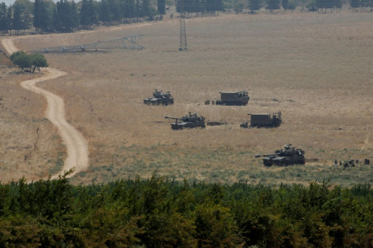 Armoured vehicles and 155 mm self-propelled howitzers are deployed in the Upper Galilee in northern Israel on the border with Lebanon on July 27