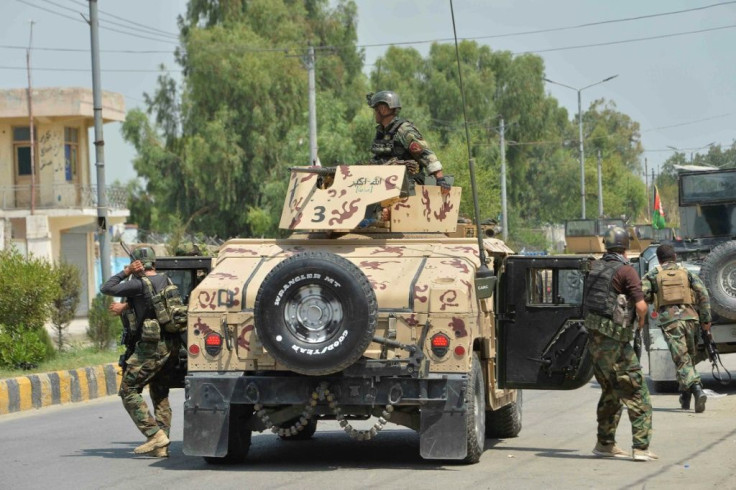 Afghan soldiers arrive during an attack on a prison in Jalalabad. At least 29 people have been killed in fighting at the jail, which houses 1,700 Islamic State and Taliban inmates