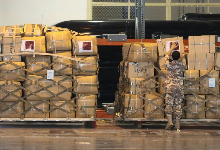 A member of Qatar's security forces organises boxes to be loaded into a plane as the Gulf country sends field hospitals and medical aid to Lebanon from an airbase near Doha