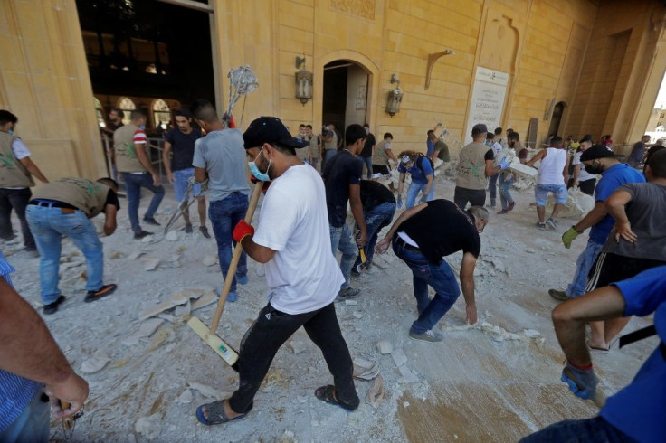 People clean debris at Mohammed al-Amin mosque in the centre of Beirut in the aftermath of a massive explosion in the Lebanese capital