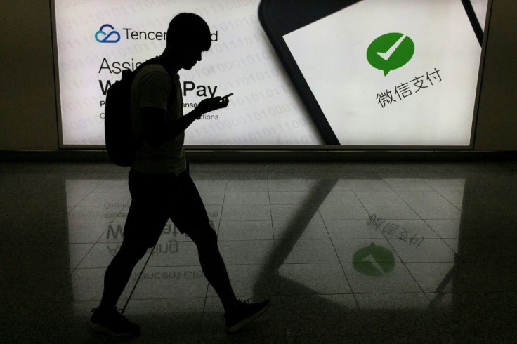A man walks past an advertisement for WeChat, which the United States is seeking to ban, at Hong Kong's international airport in 2017