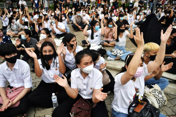 Demonstrators descended in waves to Thammasat University in the outer edges of Bangkok as the sun set