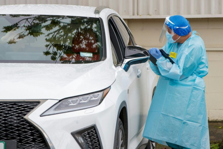 A health worker conducts a test at a COVID-19 coronavirus testing centre in the suburb of Northcote in Auckland