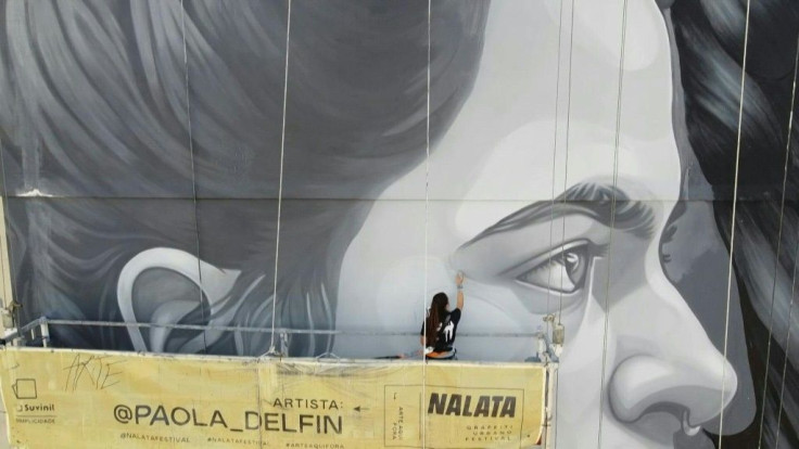 Perched atop a platform swaying in the air 10 storeys high, Paola Delfin is putting the final touches on a giant graffiti mural in the sprawling concrete jungle of Sao Paulo -- artists in the Brazilian mega-city, known as a world street art capital, have