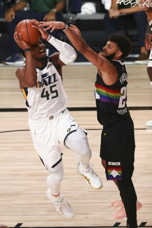 Utah's Donovan Mitchell fires against Jamal Murray of Denver in the Jazz's 124-105 NBA playoff victory over the Nuggets