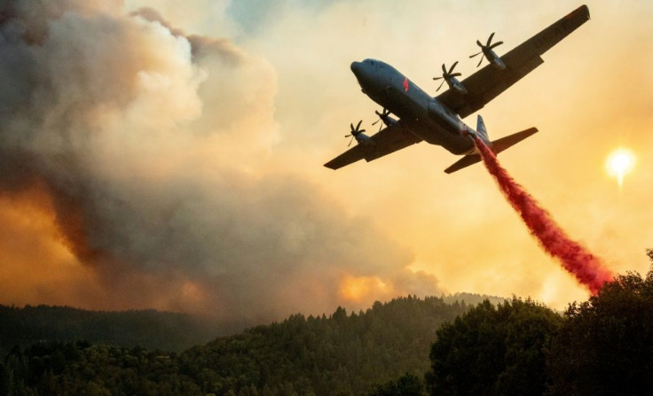 An aircraft drops fire retardant on a ridge during the Walbridge fire, part of the larger LNU Lightning Complex fire, as flames continue to spread in Healdsburg, California on August 20, 2020