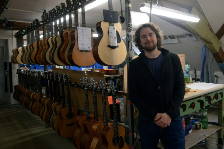 Petr Furch, son of company founder Frantisek Furch and the current chief executive of the Furch family company poses with their guitars in their production centre in Velke Nemcice, Czech Republic.