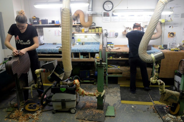 Employees of the Furch family company work on a guitar in the workshop.