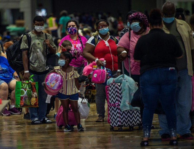 People prepare to board a bus in Lake Charles, Louisiana for evacuation before the arrival of Hurricane Laura