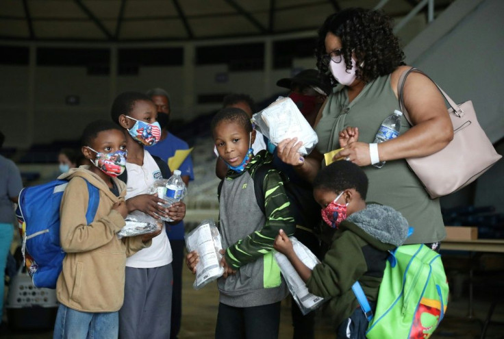 Evacuees wait to board a bus in Lake Charles, Louisiana, ahead of the arrival of Hurricane Laura