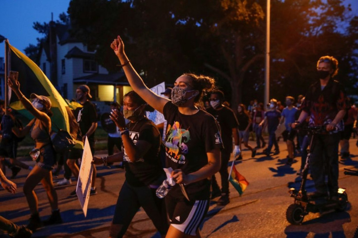 Protesters march during a demonstration against the shooting of Jacob Blake in Kenosha, Wisconsin on August 26, 2020, the fourth consecutive night of protests