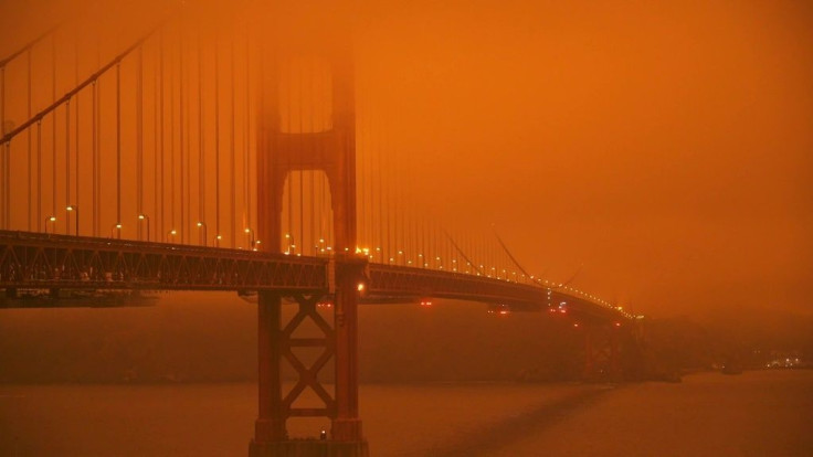 San Francisco has a deep orange-tinted sky in the morning from a thick fog of smoke caused by the outbreak of wildfires across Northern California following historically high temperatures and strong winds, with commentators noting the city's dystopian, sc