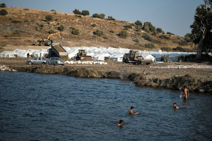 Children swim at the new temporary camp near Panagiouda