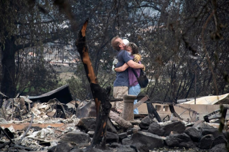 Dee Perez comforts Michael Reynolds in the ruins of his home destroyed in the Almeda Fire in Talent, Oregon