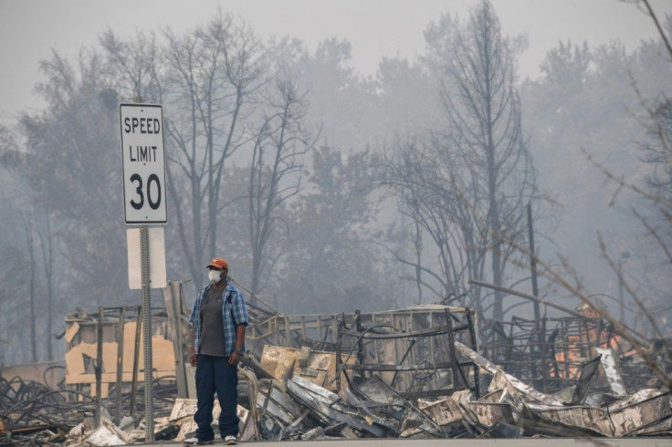 A man stands near some of the destruction caused by the Almeda Fire in Phoenix, Oregon, September 15, 2020