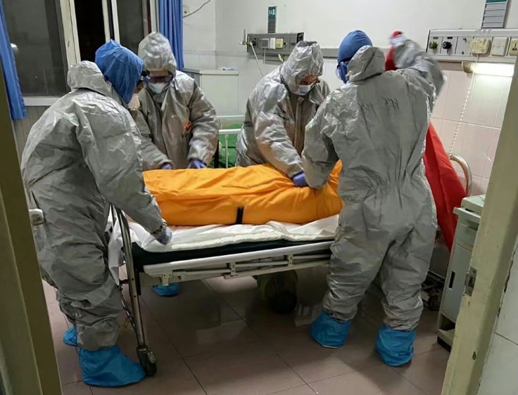 Medical workers preparing to take away the body of Zhang Lifa, the father of Zhang Hai, in a hospital in Wuhan, China on February 1